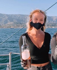Autumn van Diver serves wine while on a boat during an event with the SB Sailing Center
