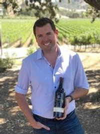 National Sales Manager, Dean McKillen, photographed in the picnic area by the pond at our estate winery holding a bottle of Cabernet Sauvignon