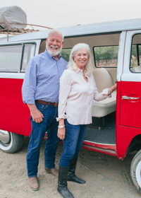 Larry & Sharon Grassini photographed in front of red vintage Chevy truck